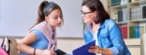Educational psychologist talking to young student